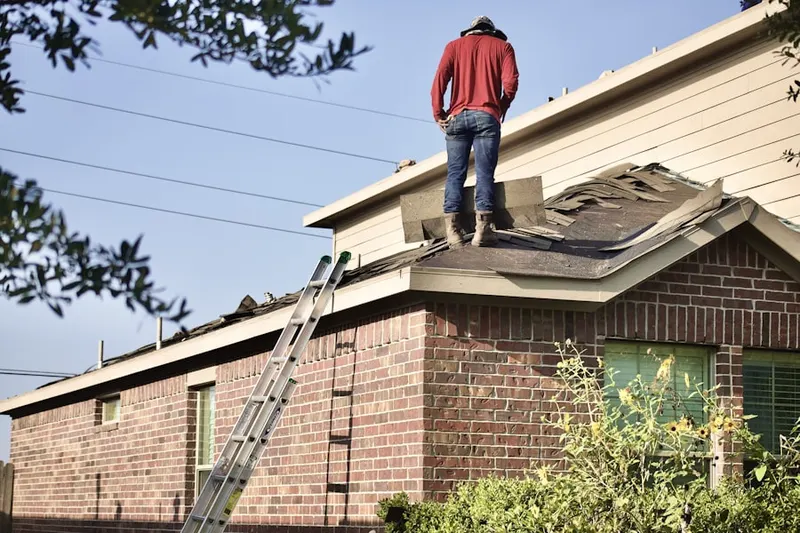 Professional roofer working on a residential roof in Josephine